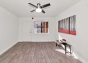 Thumbnail 5 of 36 - A room with a ceiling fan and a painting on the wall at Urban WalkApartments on 6th Avenue, Phoenix