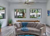 Thumbnail 25 of 29 - A living room with a couch and a ceiling fan.
