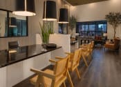 Thumbnail 9 of 76 - a kitchen and dining room with wooden chairs and a tableat Weylyn Luxury Apartments, Arizona