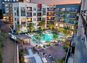 Thumbnail 1 of 26 - Crystal Clear Swimming Pool at Night at Atlanta Apartments for Rent 30339