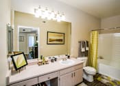 Thumbnail 13 of 18 - Full Bathroom with Soaking Tubs at Apartments in Las Vegas Nevada
