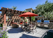 Thumbnail 5 of 27 - a patio with a table and chairs and a red umbrella