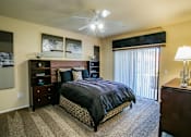 Thumbnail 17 of 27 - a bedroom with a bed and a window with a ceiling fan