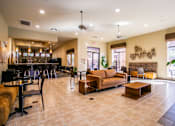 Thumbnail 9 of 27 - a lobby with couches tables and chairs and a bar