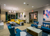 Thumbnail 3 of 15 - a living room with blue chairs and yellow couches and a coffee table