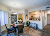 Thumbnail 11 of 18 - a dining room and kitchen area with a table and chairs in apartment in Las Vegas Nevada