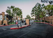 Thumbnail 18 of 18 - a parking lot in front of a building with a gate