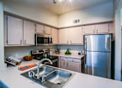 Thumbnail 7 of 18 - full kitchen with stainless steel appliances at Las Vegas Apartments For Rent