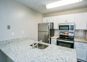 Thumbnail 12 of 19 - Kitchen with Stainless Steel Appliances at Best Apartments in Gwinnett County