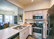 Thumbnail 6 of 18 - Updated kitchen with stainless steel appliances and white counter tops Apartments in Las Vegas