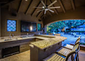Thumbnail 27 of 29 - Outdoor Resident Kitchen by Pool at Dallas Apartments for Rent