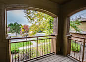 Thumbnail 15 of 25 - A view from a porch looking out to a street lined with trees.