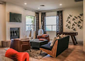 Thumbnail 12 of 25 - Clubhouse Lounge with Fireplace at Apts in Phoenix AZ