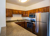 Thumbnail 6 of 25 - Full Upgraded Kitchen with Stainless Steel Appliances and Granite Countertops at Apartments in Deer Valley AZ