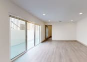 Thumbnail 5 of 20 - Living Room with Wood Vinyl Floors & Sliding Glass Doors to Private Balcony