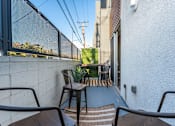 Thumbnail 22 of 26 - a balcony or terrace with chairs and a table at Lido Apartments - 4025 Grandview, California