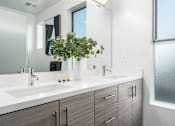 Thumbnail 17 of 26 - a bathroom with two sinks and a mirror at Lido Apartments - 4025 Grandview, California
