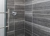 Thumbnail 25 of 26 - a tiled bathroom with a shower and a glass door at Lido Apartments - 4025 Grandview, California, 90066