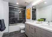 Thumbnail 13 of 26 - a bathroom with a toilet sink and shower at Lido Apartments - 4025 Grandview, Culver City, California