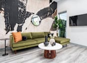 Thumbnail 5 of 26 - a living room with a geometric tile floor and a green couch at Lido Apartments - 4025 Grandview, Culver City, California