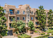 Thumbnail 1 of 8 - A large, multi-story residential building with a balcony on the second floor.