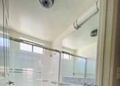 Thumbnail 7 of 7 - A bathroom with a toilet, sink, and shower.