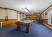 Thumbnail 4 of 23 - a game room with a pool table