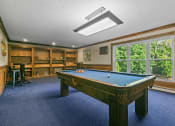 Thumbnail 6 of 23 - a game room with a pool table and a bar