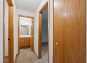 Thumbnail 6 of 21 - the entrance to a bathroom and a hallway with a door to a bedroom