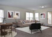 Thumbnail 1 of 32 - A living room with a couch, a chair, a table, and a potted plant.