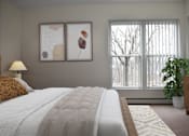 Thumbnail 15 of 32 - A bedroom with a large bed and two framed artworks on the wall.
