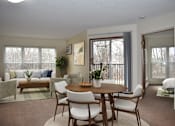 Thumbnail 7 of 32 - A dining room with a table set for six.