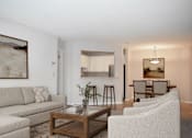 Thumbnail 3 of 26 - A living room with a couch, chairs, and a coffee table.