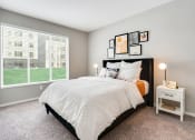 Thumbnail 4 of 31 - a bedroom with a large window and a bed