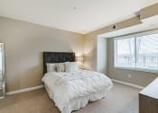 Thumbnail 9 of 25 - Bedroom with white comforter on the bed