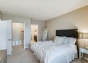 Thumbnail 8 of 25 - Bedroom with white comforters and bathroom and closet in frame