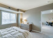 Thumbnail 7 of 25 - Bedroom with a dresser and bed and light green walls