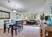 Thumbnail 2 of 23 - a living and dining room area with a table and chairs and a couch in the background