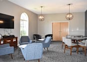 Thumbnail 3 of 16 - A living room with a grey carpet and a wooden dining table.