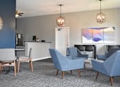 Thumbnail 1 of 16 - A modern living room with grey and blue chairs.