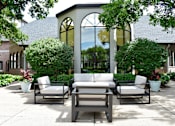 Thumbnail 4 of 27 - A patio with a couch, chairs and plants.