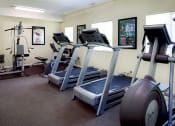 Thumbnail 16 of 22 - a room with three treadmills and other exercise equipment