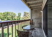 Thumbnail 14 of 32 - Private deck with chairs and a view of trees