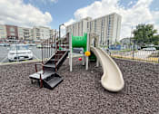 Thumbnail 5 of 20 - A playground with a slide, stairs, and a platform.