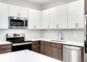 Thumbnail 34 of 44 - kitchen with brown and white shelves and stainless steel appliances