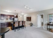 Thumbnail 5 of 25 - Kitchen  and living room with an open door to the bedroom