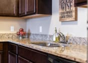 Thumbnail 2 of 25 - A kitchen counter, a sink, and a sign that says "Good Wine, Good Friends, Good Times"