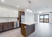 Thumbnail 31 of 44 - kitchen overlooking empty living room and sliding glass door leading to balcony