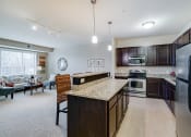 Thumbnail 3 of 25 - Living room and kitchen
