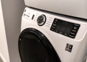 Thumbnail 24 of 44 - modern, white laundry washing machine with black door and knobs